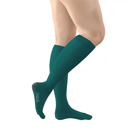 Lower legs wearing teal knee-high socks, crossed at the ankles.