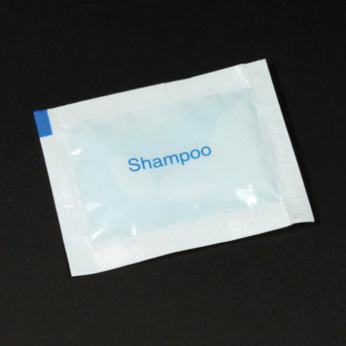 Single-use shampoo sachet on a black background