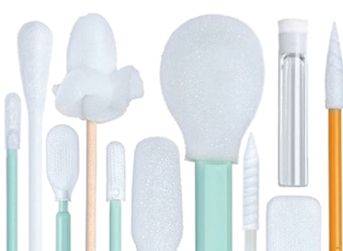 Assorted pastel makeup and cosmetic applicators arranged in a row: cotton swabs, balls, and sponges in light blue and mint tones.