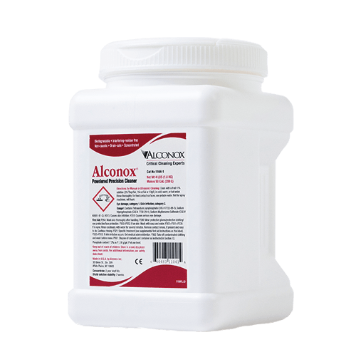 White plastic container of Alconox powdered precision cleaner with red label and screw cap, used for laboratory cleaning.